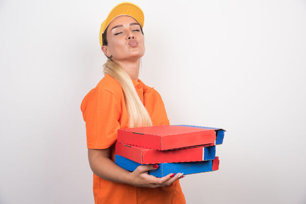 快乐带着黄色帽子拿着披萨盒的送货员用餐年轻手势
