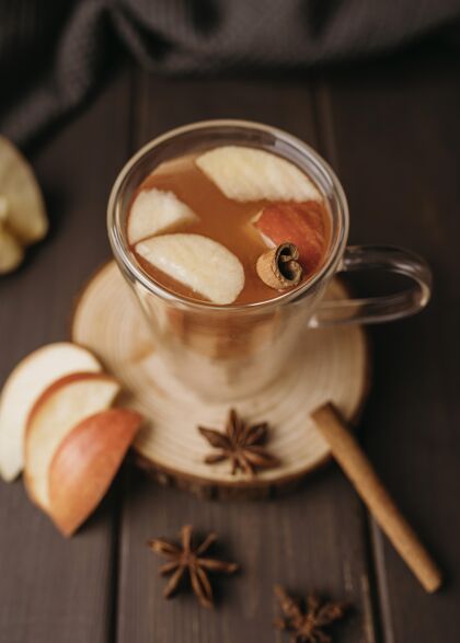 节日高角度冬季热饮料在玻璃与苹果和肉桂自制传统美味