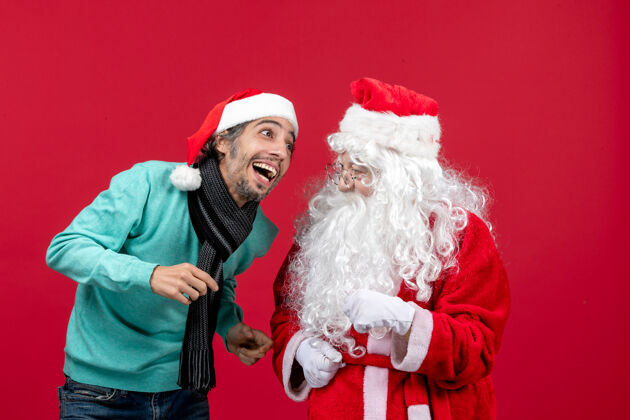 帽子正面图：圣诞老人和年轻的男性站在一起红色圣诞老人圣诞