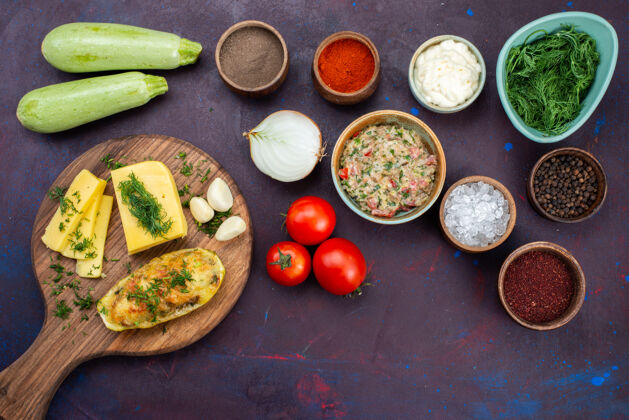 菜在深紫色的桌子上俯瞰烤南瓜 配上芝士绿 肉末和新鲜蔬菜午餐烘焙食物