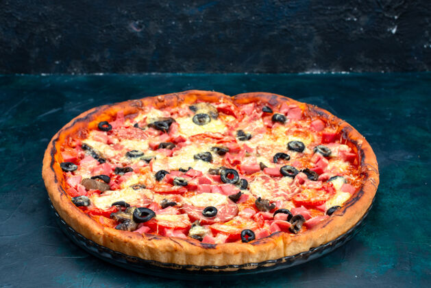 美味前视图烤美味的比萨饼与橄榄香肠和奶酪在蓝色的桌子上美味烘焙前面